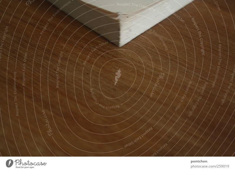 Part of a white book. Book corner on wooden table. Reading and education Leisure and hobbies Living or residing Brown White Paper Wood grain Empty Page