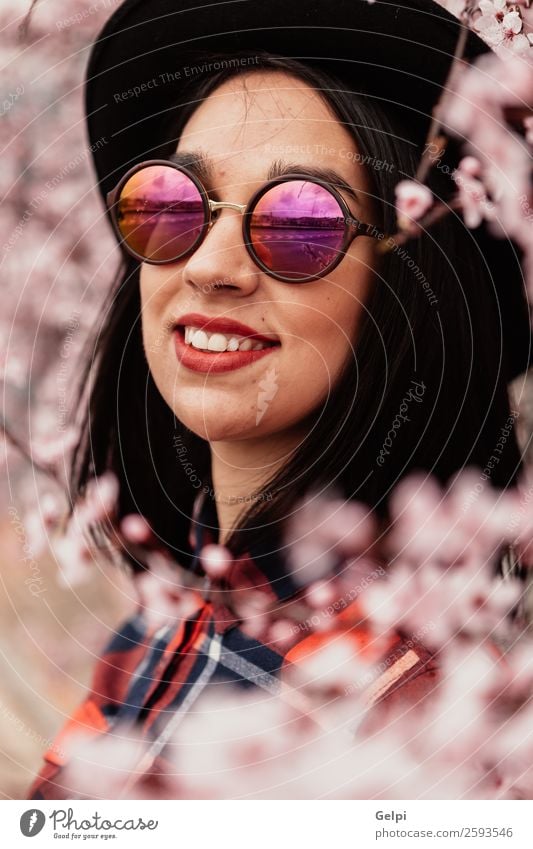 Pretty brunette girl Style Happy Beautiful Face Garden Human being Woman Adults Nature Tree Flower Blossom Park Fashion Sunglasses Hat Brunette Smiling