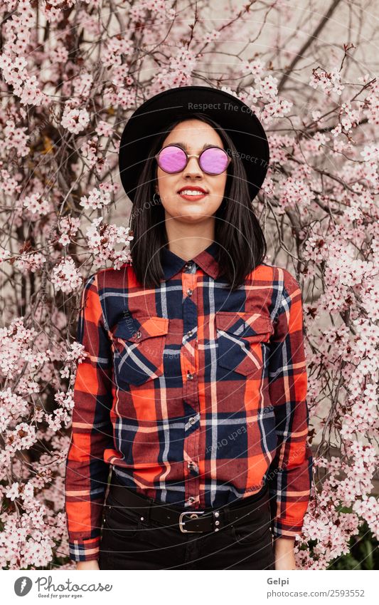 Pretty brunette girl Style Happy Beautiful Face Garden Human being Woman Adults Nature Tree Flower Blossom Park Fashion Sunglasses Hat Brunette Smiling