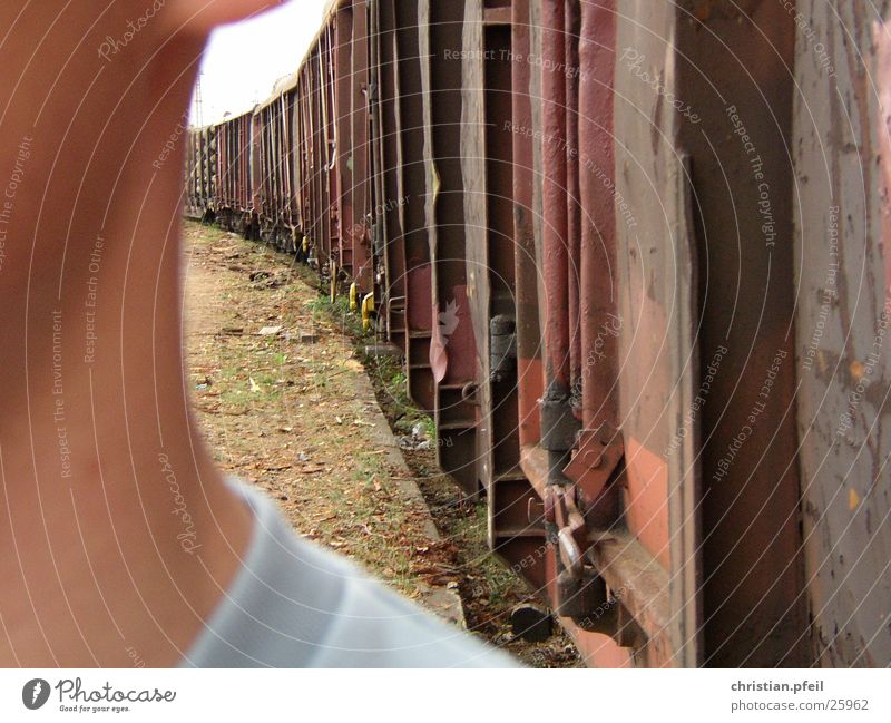 Over the shoulder at the freight station Close-up Shoulder Half Red Railroad Freight station Man Near close Face Goods Train station Rust train car