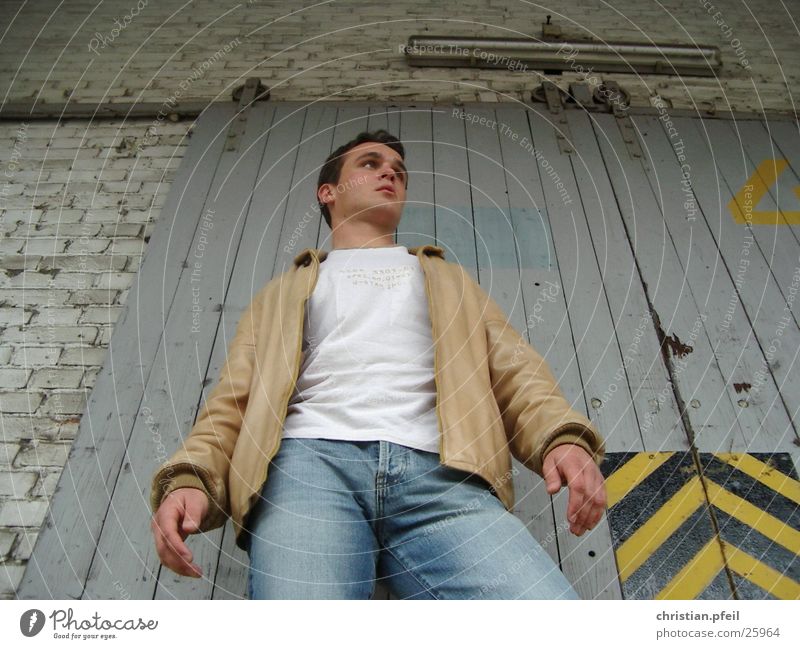 Low angle at the freight station Deep Railroad Freight station Consign Easygoing Under Worm's-eye view Style Stripe Engines Historic Man Earnest Leather Jacket