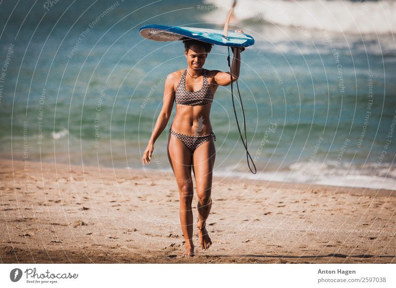 Surfer girl carrying blue single fin surfboard from the ocean Lifestyle Vacation & Travel Trip Adventure Freedom Summer vacation Sun Beach Ocean Island Waves