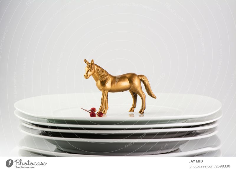 Plates stacked dishes and gold horse. conceptual food holiday Food Dinner Crockery Table Kitchen Restaurant Feasts & Celebrations Valentine's Day Mother's Day