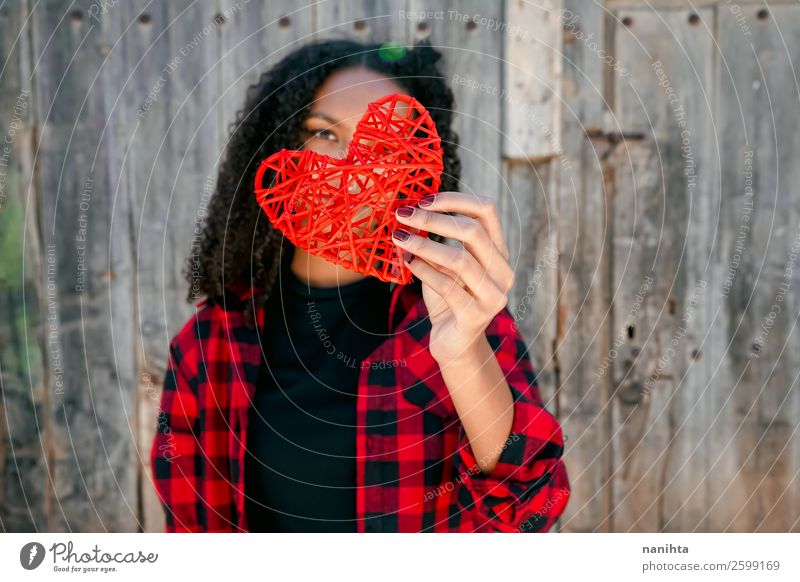 Beautiful young woman holding a red heart Lifestyle Style Joy Hair and hairstyles Healthy Wellness Human being Feminine Young woman Youth (Young adults) Woman