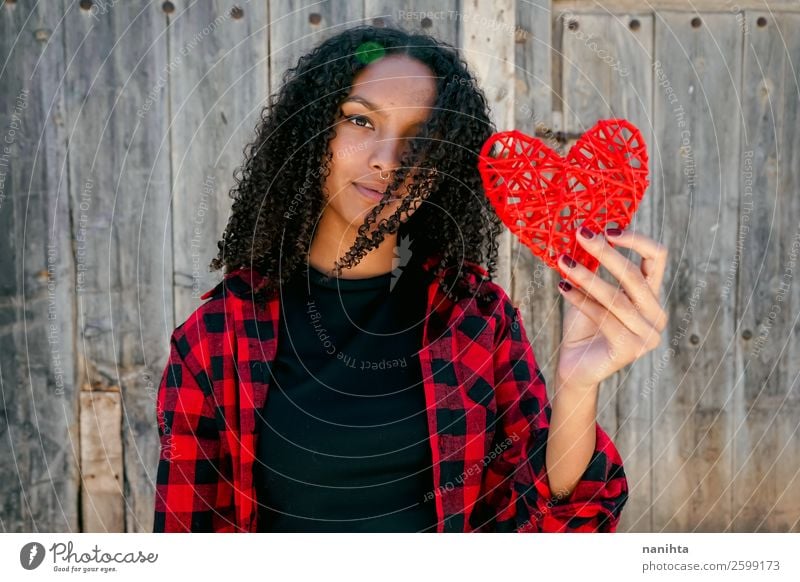 Beautiful young woman holding a red heart Lifestyle Style Joy Hair and hairstyles Human being Feminine Young woman Youth (Young adults) Woman Adults 1