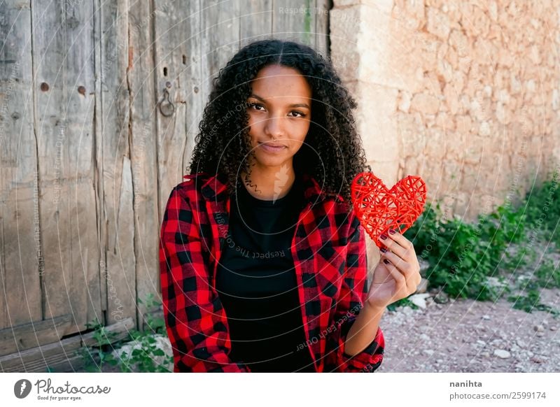 Beautiful young woman holding a red heart Lifestyle Style Joy Hair and hairstyles Human being Feminine Young woman Youth (Young adults) Woman Adults 1