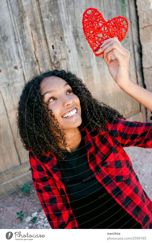 Beautiful young woman holding a red heart Lifestyle Style Joy Hair and hairstyles Human being Feminine Young woman Youth (Young adults) Woman Adults 1