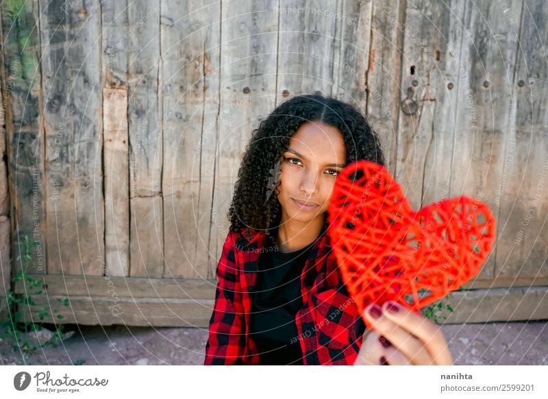 Beautiful young woman holding a red heart Lifestyle Style Joy Hair and hairstyles Healthy Health care Human being Feminine Woman Adults Youth (Young adults) 1