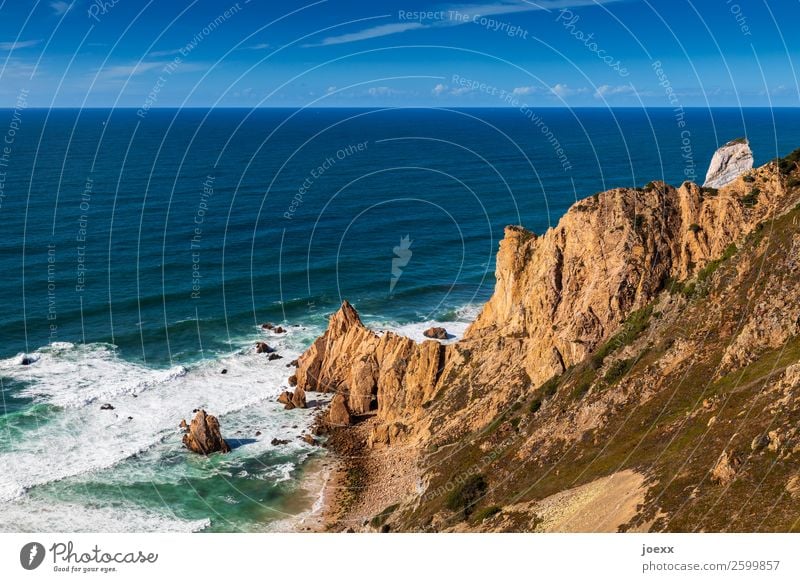 Brown rocky coast into the blue sea with waves and spray Ocean Rock Waves Landscape Sky Horizon Beautiful weather Deserted Exterior shot Day Water Summer