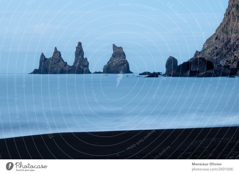 Rocks in the sea near Vik, Iceland, Ocean Coast Deserted Beach Landscape Nature Travel photography Adventure Exterior shot Blue