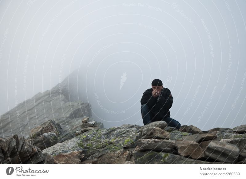 Man on a cliff in high mountains Human being Adults 1 Nature Elements Bad weather Rock Mountain Peak Canyon Cap Freeze Hiking Threat troll wall troll harrows