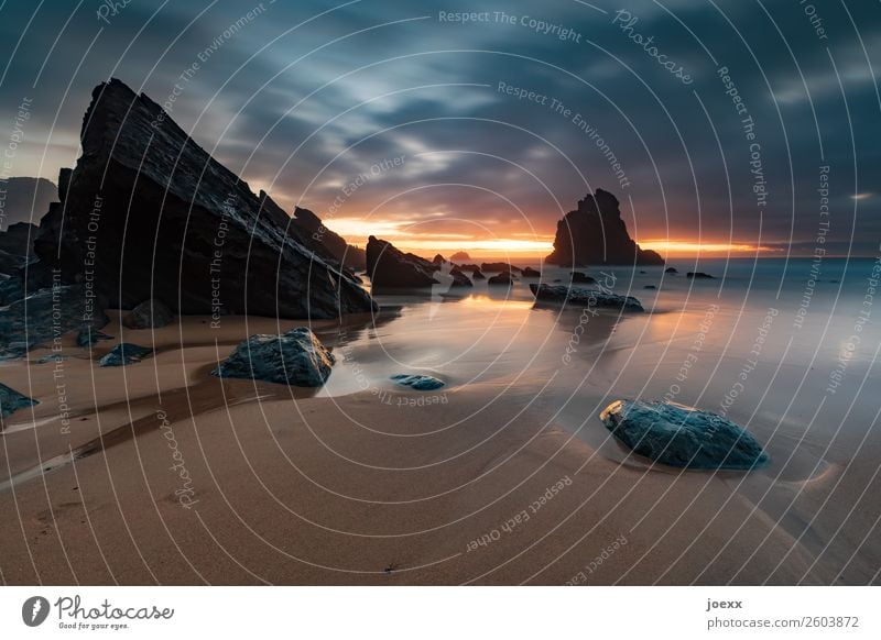 Beach with angular rocks at sunset, long time exposure Praia da Adraga Rock Large Warmth Sunset Orange Deserted Horizon Clouds Portugal Nature Ocean