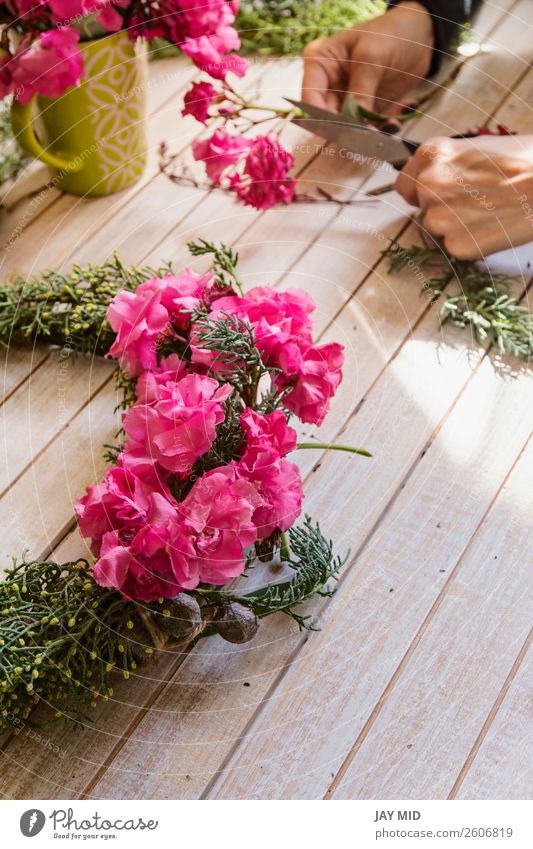 Florist Creating a wooden wreath with pine branches and flower Handicraft Decoration Feasts & Celebrations Valentine's Day Mother's Day Thanksgiving