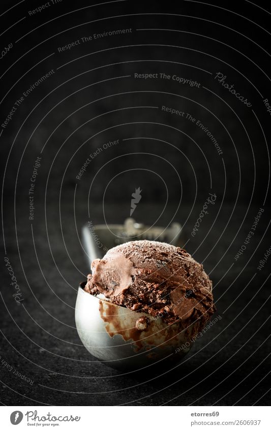 Chocolate ice cream on black stone background Ice cream Sweet Candy Summer Cream Scoop Dessert Frozen Rich Cold Rich in calories Brown Confectionary Food