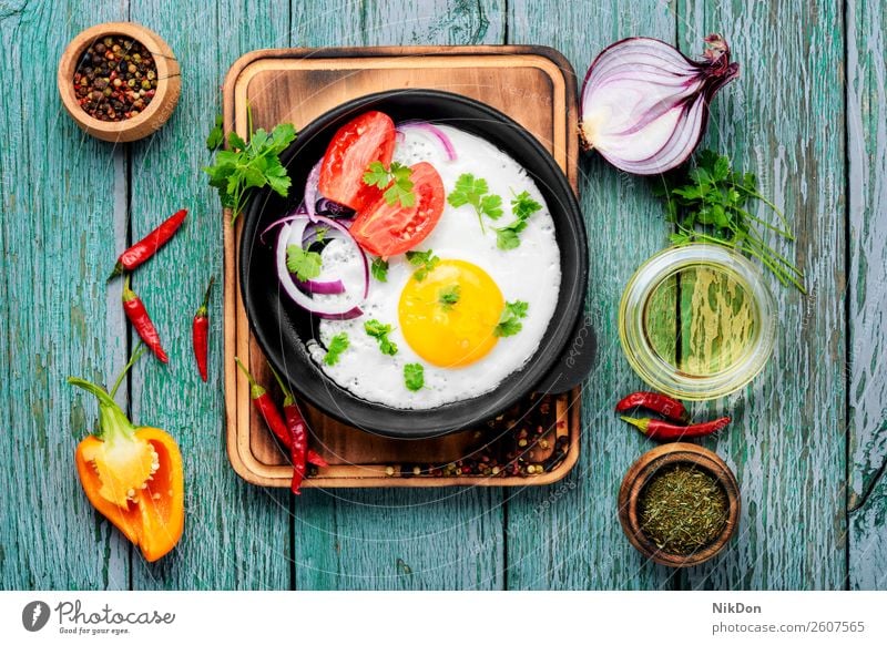 Tasty food fried egg pan morning breakfast grilled egg yellow meal healthy yolk protein lunch cholesterol table dish delicious cook diet kitchen pepper fry eat