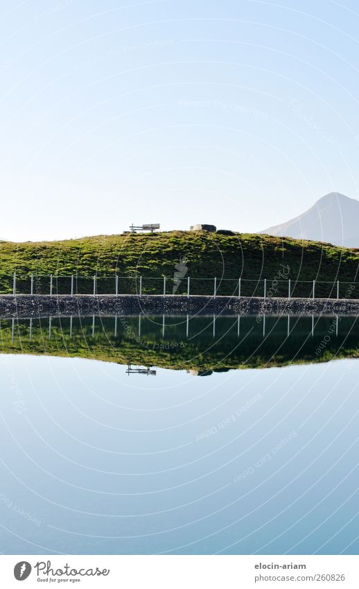 Find the "mistake." Nature Landscape Water Sky Cloudless sky Grass Meadow Hill Mountain Lake Relaxation Swimming & Bathing Sit Blue Brown Green Happy