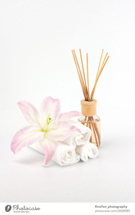 Spa decoration with pink lily, white towels and aroma oil Bottle Luxury Beautiful Body Skin Cosmetics Medical treatment Wellness Relaxation Meditation Massage