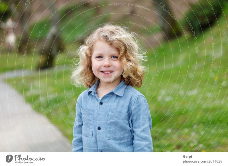 Happy small child with long blond hair Beautiful Face Summer Child Human being Baby Boy (child) Man Adults Infancy Environment Nature Plant Shirt Blonde Smiling