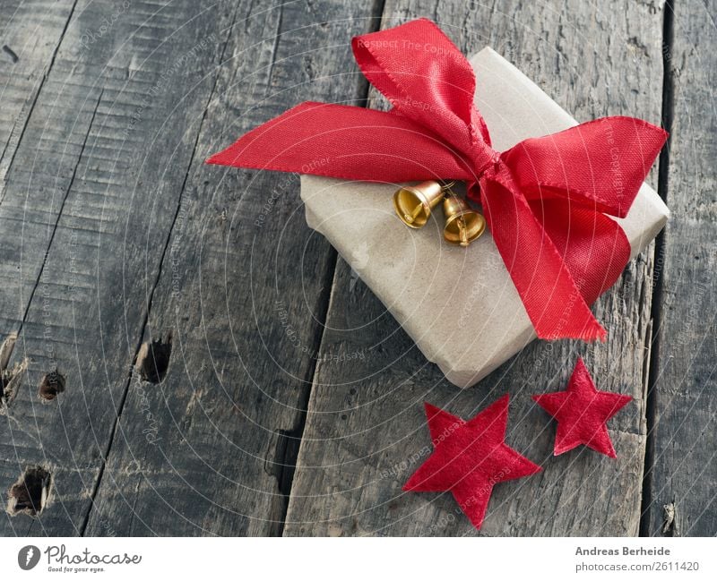 A gift with ribbons and bells Style Winter Christmas & Advent Anticipation Joy golden merry new nobody plank present red rustic season seasonal space Starling