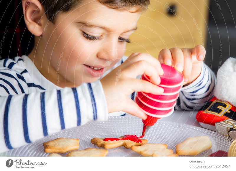 Little kid decorating Christmas biscuits at Christmas day Dough Baked goods Dessert Candy Joy Happy Leisure and hobbies Decoration Table Kitchen