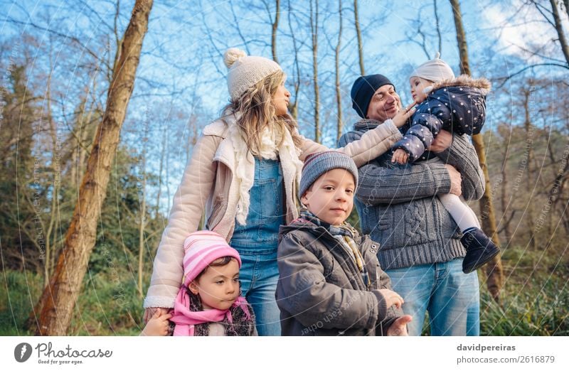 Portrait of happy family enjoying together leisure over a wooden pathway into the forest Lifestyle Joy Happy Leisure and hobbies Winter Child Boy (child) Woman