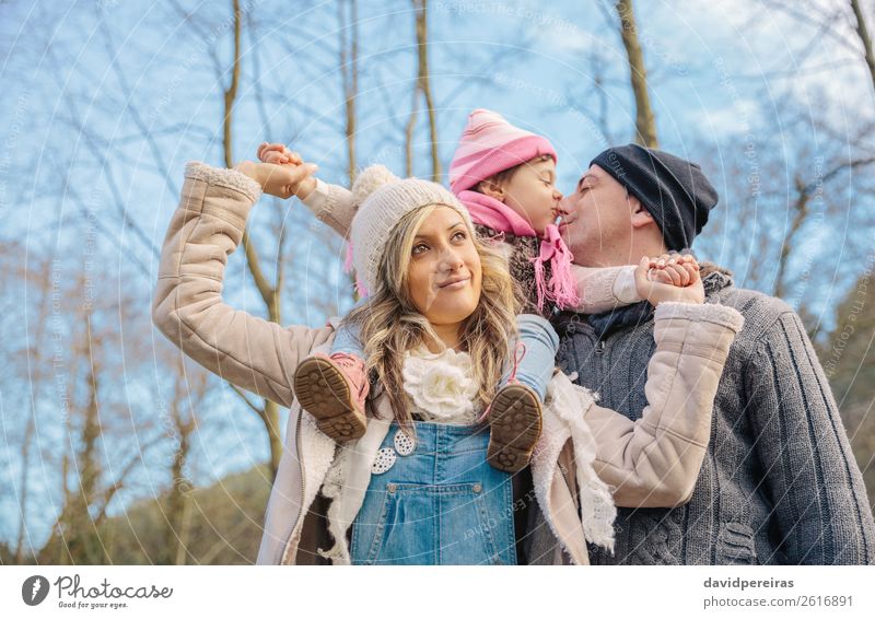 Happy couple with daughter in the forest Lifestyle Joy Leisure and hobbies Winter Child Woman Adults Man Parents Mother Father Family & Relations Couple Hand