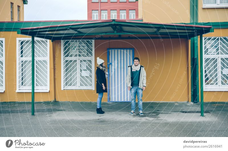 Couple standing under metallic roof in rainy day Lifestyle Happy Beautiful Relaxation Winter Human being Woman Adults Man Friendship Autumn Rain Street Clothing