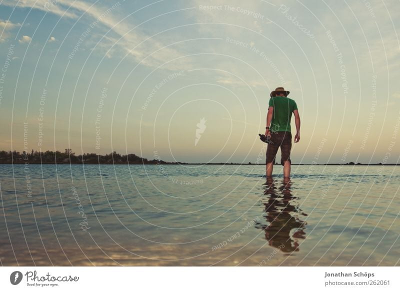 Man with hat stands in shallow water on the beach Vacation & Travel Trip Adventure Far-off places Freedom Summer Summer vacation Beach Ocean Human being