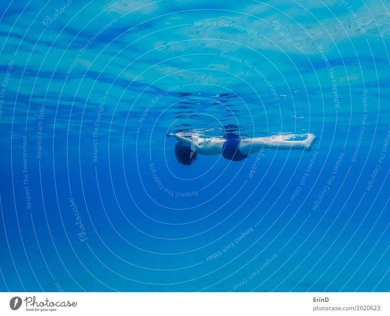 Woman Floats on Surface of Ocean from Underwater Joy Beautiful Relaxation Calm Meditation Vacation & Travel Tourism Adventure Environment Nature Breathe