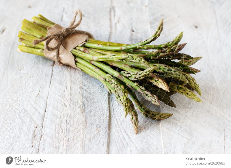 Fresh raw asparagus spears on a white table Vegetable Nutrition Dinner Vegetarian diet Diet Table Green White Asparagus Raw Rustic seasonal Vegan diet Bundle