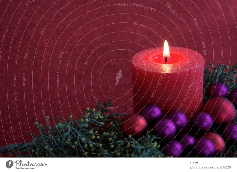 Red candle with christmas decoration I Feasts & Celebrations Christmas & Advent Religion and faith Moody Candle 1 Flame Copy Space Glitter Ball Violet Green