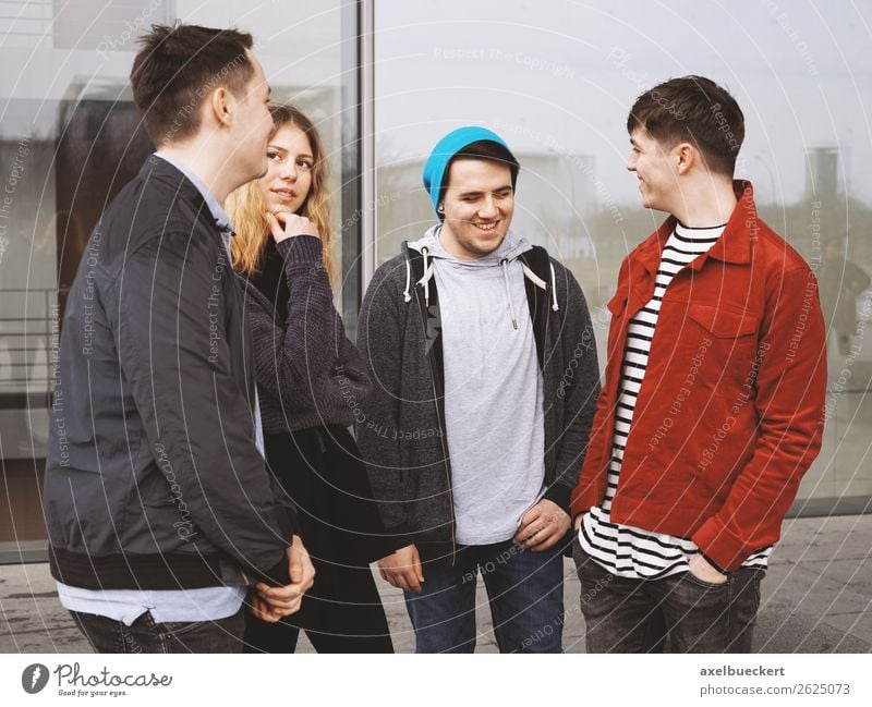 Group of teenage friends talking and laughing together Lifestyle Joy Leisure and hobbies Human being Masculine Feminine Young woman Youth (Young adults)