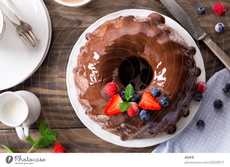 Chocolate bundt cake with berries Fruit Dessert Breakfast Hot Chocolate Coffee Tea Birthday Leaf Wood Fresh Brown chocolate glaze Berries Strawberry Blackberry