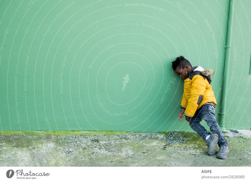 Tired and bored little boy on the street Child Toddler Boy (child) Street Coat Small Anger Yellow Green Black Emotions Fatigue Loneliness Frustration Innocent