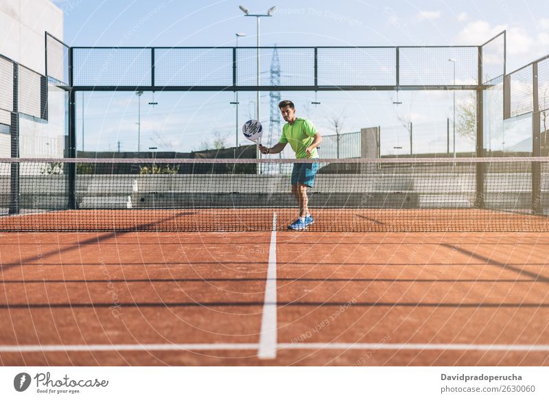 Sportsman playing padel game Glass Court building Joy Leisure and hobbies Exterior shot Match paddel tournament Looking away padel tennis Playing Tennis