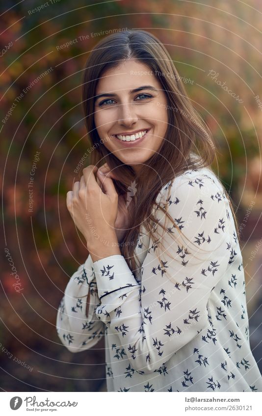 Attractive young woman in a colorful fall street Happy Woman Adults 1 Human being 18 - 30 years Youth (Young adults) Autumn Leaf Street Fashion Brunette Smiling