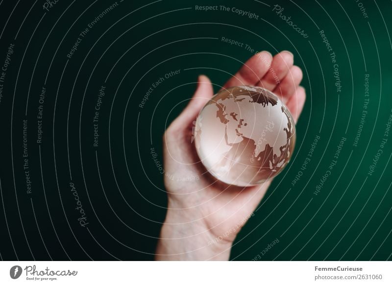 Hand with transparent globe in front of green background Nature Horizon Globe Earth Transparent To hold on Green Dark green Asia Europe Africa Saudi Arabia