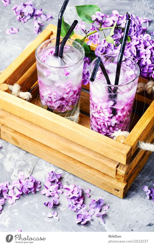 Refreshing drink with lilac and ice glass cocktail beverage flower juice cold water refreshment summer bar healthy natural violet cool liquid freshness purple