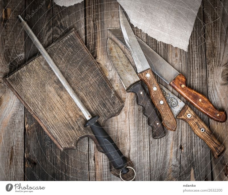 wooden cutting board and knife with sharpening on the table Knives Table Kitchen Tool Nature Wood Metal Steel Rust Old Dirty Retro Brown iron background Blank