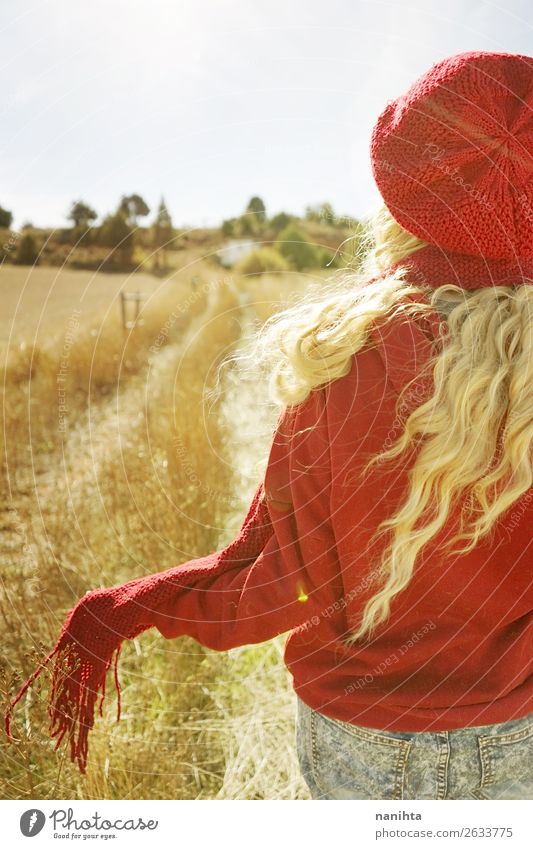 Back view of a young woman in nature in a sunny autumn day Happy Beautiful Leisure and hobbies Adventure Freedom Sun Child Woman Adults Youth (Young adults)