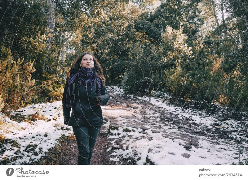 Girl fooling around on a snowy mountain road in winter Design Joy Happy Beautiful Vacation & Travel Trip Adventure Winter Snow Mountain Woman Adults Environment