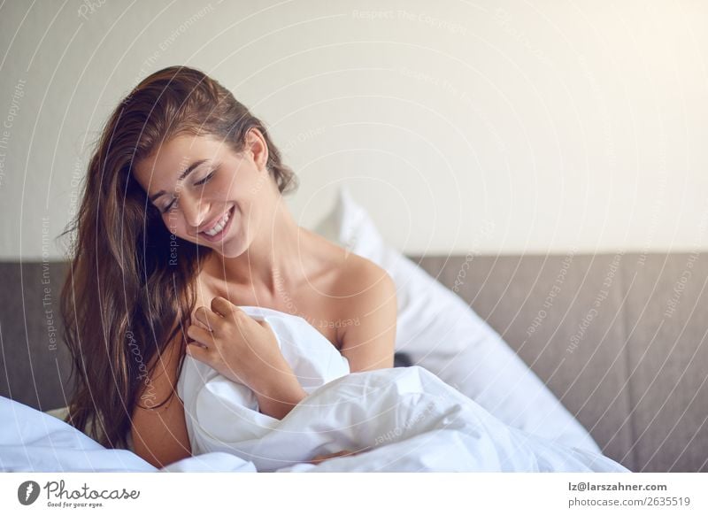 Young woman sitting in bed and smiling Happy Beautiful Relaxation Bedroom Woman Adults 1 Human being 18 - 30 years Youth (Young adults) Brunette Smiling Sleep