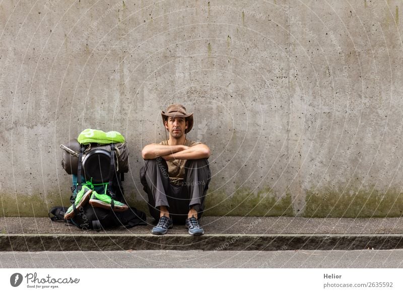 Backpacker takes a break from travelling by hitchhiker Lifestyle Vacation & Travel Tourism Trip Adventure Far-off places Freedom City trip Human being Man