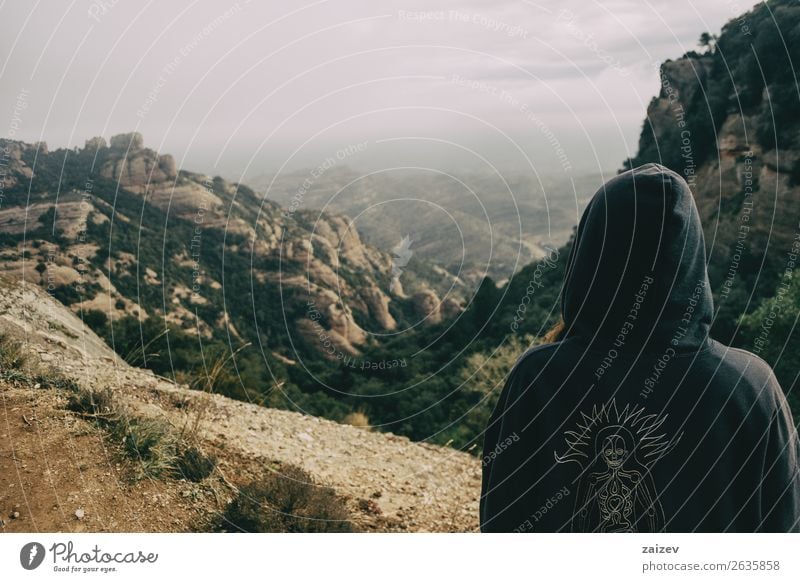 Girl on her back with a hood looking at a landscape of mountains on a day with clouds Lifestyle Beautiful Relaxation Vacation & Travel Tourism Trip Adventure