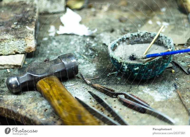 Top view of different goldsmiths tools on the jewelry workplace. Table Work and employment Profession Workplace Industry Craft (trade) Tool Hammer Hand Art Rock