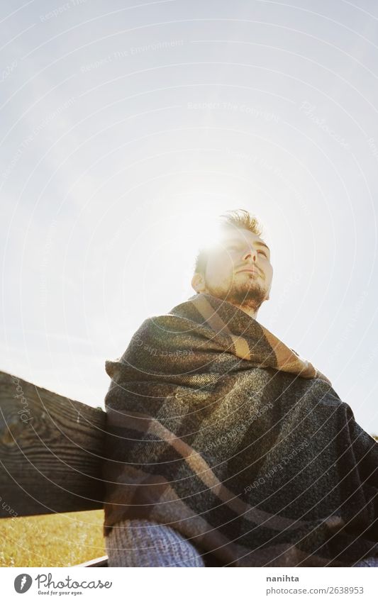 A head-on young man enjoying the calm Lifestyle Happy Face Relaxation Calm Freedom Sunbathing Human being Man Adults Sky Autumn Scarf Wood To enjoy