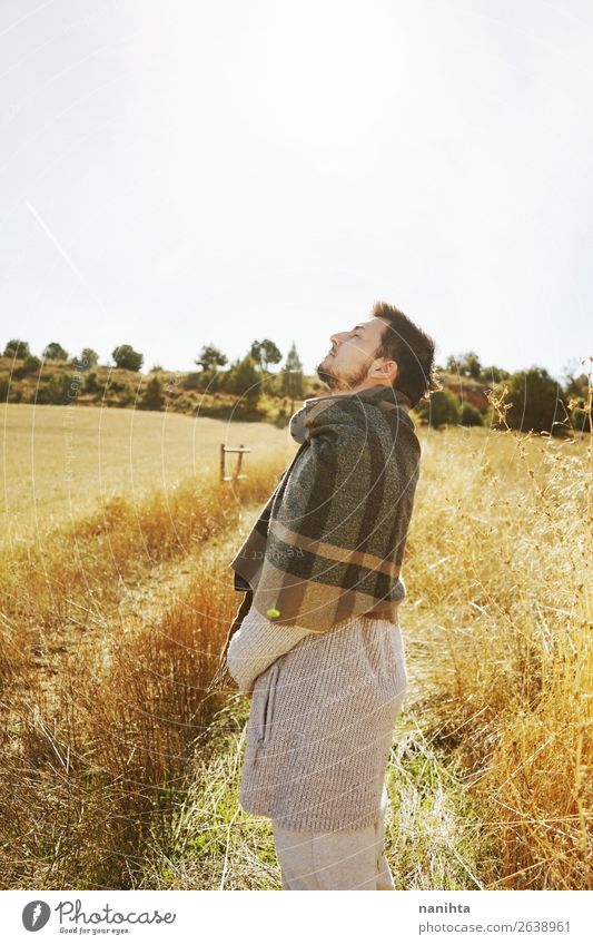 Side of a stand young man enjoying a sunny day Lifestyle Happy Face Relaxation Calm Freedom Sunbathing Human being Man Adults 1 Sky Autumn Beautiful weather