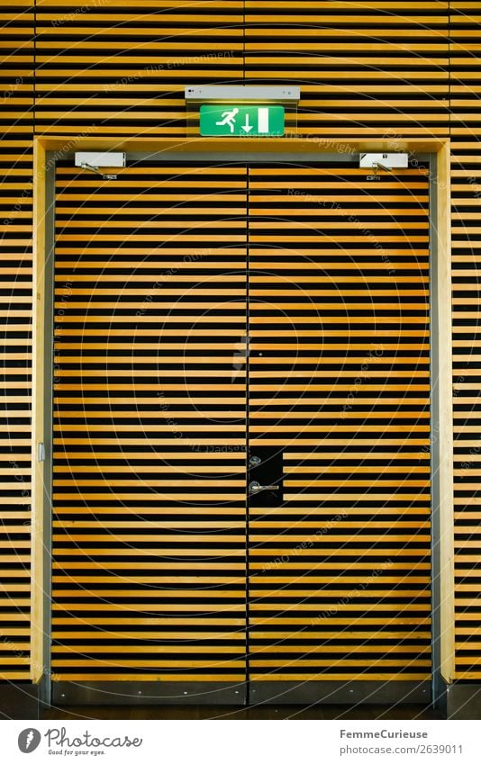 Yellow-black striped emergency exit door Airport Safety Emergency exit Striped yellow-black Black Door Way out Neon sign Colour photo Interior shot