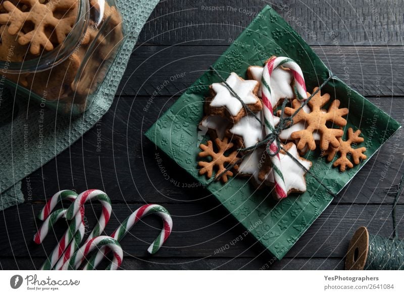 Gingerbread cookies and candy cane on a napkin. Cake Dessert Candy Feasts & Celebrations Christmas & Advent Delicious Sweet Tradition above view Bakery