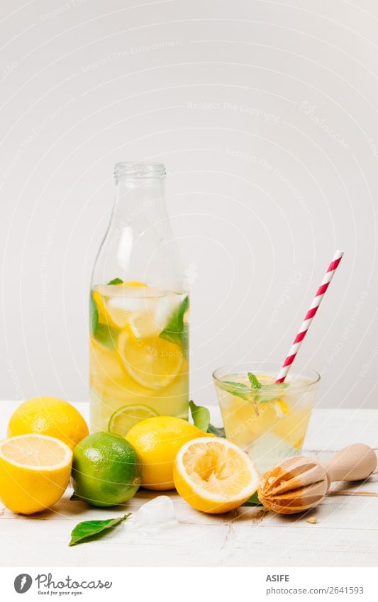 Fresh homemade lemonade on white background Fruit Diet Beverage Lemonade Juice Bottle Summer Table Leaf Wood Cool (slang) Yellow Green White lime citrus Mint